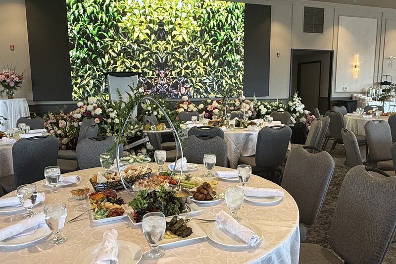 Banquet hall at Bingemans set with round tables and a floral display for a social event